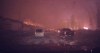 Orange embers from a wildfire fly across a road in Fort McMurray, Alta., in this Wednesday, May 4, 2016 photo taken from dash cam video.  (The scene is in Video 3 below at around the 1:25 point) A Fort McMurray man who captured his harrowing drive out of the burning city on a dash cam says he will be donating proceeds of the popular video to fire victims. Michel Chamberland posted the video on YouTube after he and about 80,000 other residents had to flee the community on Tuesday. YouTube / Michel Chamberland / THE CANADIAN PRESS