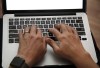 A person works on a laptop in North Andover, Mass., June 19, 2017. The Capital One breach is the latest indication of what experts say is a growing problem, as companies hold more personal data and hackers see more ways to profit off of it. THE CANADIAN PRESS/AP/Elise Amendola