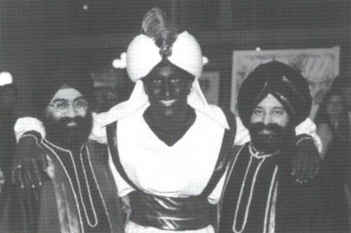 This April, 2001 photo which appeared in a newsletter from the West Point Grey Academy, shows a costumed Prime Minister Justin Trudeau, his face and hands darkened by makeup, attending a