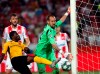 Red Star's goalkeeper Milan Borjan, center, makes a save in front of Young Boys' Nicolas Moumi Ngamaleu during the Champions League play-off, second leg soccer match between Red Star and Young Boys on the stadium Rajko Mitic in Belgrade, Serbia, Tuesday, Aug. 27, 2019. Borjan speaks English, Spanish, Bulgarian and Serbo-Croatian ??? variations of which cover Bosnia, Serbia, Croatia and Montenegro ??? understands Turkish and has a little Romanian and Polish in his language repertoire. But the Red Star Belgrade goalkeeper wears his allegiance to Canada via a Maple Leaf and words from 