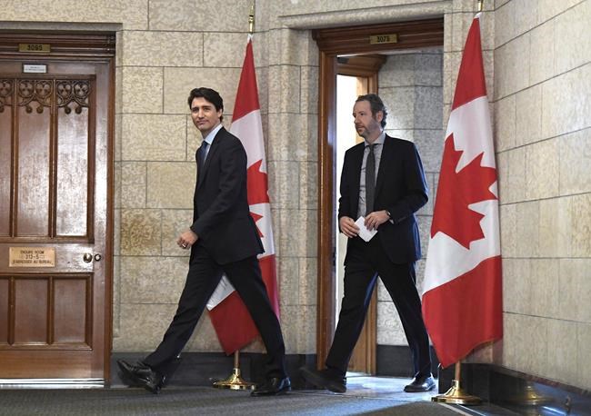 Prime Minister Justin Trudeau leaves his office with his principal secretary Gerald Butts to attend an emergency cabinet meeting on Parliament Hill in Ottawa on Tuesday, April 10, 2018. Butts has resigned amid allegations that the Prime Minister's Office interfered to prevent criminal prosecution of SNC-Lavalin. THE CANADIAN PRESS/Justin Tang