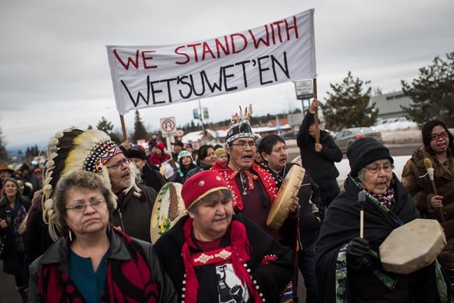 Hereditary Chief Ronnie West, centre, from the Lake Babine First Nation, sings and beats a drum during a solidarity march after Indigenous nations and supporters gathered for a meeting to show support for the Wet'suwet'en Nation, in Smithers, B.C., on January 16, 2019. More than 200 Canadian musicians and industry players are standing in solidarity with people from a northern B.C. First Nation as they protest the construction of a natural gas pipeline on traditional territories. THE CANADIAN PRESS/Darryl Dyck