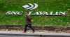 A man walks past the headquarters of SNC Lavalin in Montreal on November 6, 2014. For more than a century, SNC-Lavalin has been viewed with pride in Quebec as it grew from a small firm specializing in hydraulics into a global engineering and construction giant.Founded in 1911, it gained a reputation for building a large dam in Quebec that spearheaded the province's development of hydroelectricity and developing the skillsets for thousands of Quebec workers. THE CANADIAN PRESS/Paul Chiasson