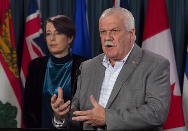 PSAC President Chris Aylward speaks as PIPSC President Debi Daviau looks on during a news conference in Ottawa on October 31, 2018. There could be a federal public-service strike later this year, but it will be up to whoever forms government after the October election to deal with it. The Public Service Alliance of Canada -- the civil service's biggest union -- has walked away from talks aimed at reaching new contracts affecting more than 100,000 workers. The union first declared an impasse in talks impacting 90,000 of its members May 2. On Thursday, it did the same thing in talks involving about 24,000 employees of the Canada Revenue Agency. THE CANADIAN PRESS/Adrian Wyld