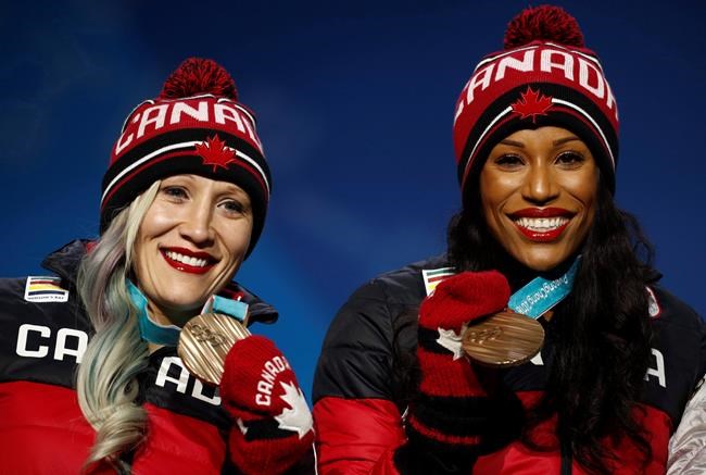 Bronze medallists in the women's two-man bobsled Kaillie Humphries and Phylicia George, of Canada, smile during the medals ceremony at the 2018 Winter Olympics in Pyeongchang, South Korea, Thursday, Feb. 22, 2018. A Calgary judge is expected to rule on whether Bobsleigh Canada Skeleton must release Humphries to compete for another country. THE CANADIAN PRESS/AP/Patrick Semansky