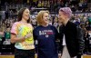 Seattle Mayor Jenny Durkan, center, wears a T-shirt honoring Megan Rapinoe, right, of the U.S. women's World Cup championship soccer team, and Seattle Storm's Sue Bird, left, as Rapinoe was introduced during the first half of a WNBA basketball game between the Storm and the Dallas Wings on Friday, July 12, 2019, in Seattle. The mayors of Toronto and Seattle are making a friendly wager as their cities' Major League Soccer teams prepare to face off in the league's championship match this weekend. THE CANADIAN PRESS/AP/Elaine Thompson