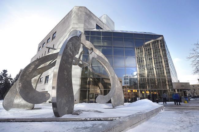 People enter the Law Courts in Winnipeg on Monday, February 5, 2018. The Manitoba government has reached a settlement with a woman who said she was violently tackled by sheriffs inside the Winnipeg courthouse. THE CANADIAN PRESS/John Woods