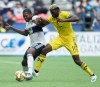 Vancouver Whitecaps' Doneil Henry, left, and Columbus Crew's Gyasi Zardes vie for the ball during the first half of an MLS soccer game in Vancouver on Saturday, Sept. 21, 2019. They may be out of playoff contention but the Whitecaps still manages to set a Major League Soccer record over the weekend. Three Canadian ???Caps scored in Vancouver???s 4-3 win over the L.A. Galaxy, setting a new league-high for goals by Canadian players. THE CANADIAN PRESS/Darryl Dyck