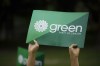 A supporter holds a sign for the Green Party of Canada in Toronto, Tuesday, Sept. 3, 2019. The federal Green party has accepted an election candidate's resignation over a social-media post in which he mused about sending pig meat to devotees of Muhammad. THE CANADIAN PRESS/Cole Burston