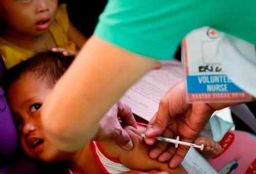Philippine National Red Cross and Health Department volunteers conduct house-to-house measles vaccination to children at an informal settlers community in Manila, Philippines, following an outbreak of measles that already spread to four regions in the country and has claimed the lives of more than five dozen victims Saturday, Feb. 16, 2019. THE CANADIAN PRESS/AP-Bullit Marquez
