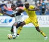 Vancouver Whitecaps' Doneil Henry, left, and Columbus Crew's Gyasi Zardes vie for the ball during the first half of an MLS soccer game in Vancouver on Saturday, Sept. 21, 2019. THE CANADIAN PRESS/Darryl Dyck
