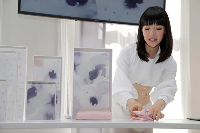 Japanese organizational expert Marie Kondo folds an item of clothing as she introduces her new line of storage boxes during a media event in New York on July 11, 2018. A decluttering craze fuelled by Marie Kondo's new Netflix show is sparking joy for adherents, but also highlighting the hurdles and unspoken practices of what it takes to live with less. There is a dark side to a minimalist movement in which a good chunk of unwanted belongings ends up in the trash despite good intentions, say garbage, recycling and donation collectors who are ramping up publicity efforts to make sure useful items don't end up in landfill. THE CANADIAN PRESS/AP, Seth Wenig