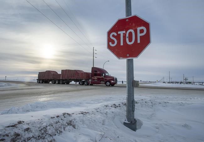 A truck goes through the intersection near the memorial for the 2018 crash where 16 people died and 13 injured when a truck collided with the Humboldt Broncos hockey team bus, at the crash site on Wednesday, January 30, 2019 in Tisdale, Sask. Saskatchewan's privacy commissioner has found eight people inappropriately accessed the electronic health records of ten Humboldt Broncos team members involved in the bus crash last April. THE CANADIAN PRESS/Ryan Remiorz