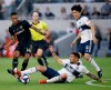 Los Angeles FC midfielder Mark-Anthony Kaye, left, passes the ball as Vancouver Whitecaps defender Erik Godoy, center, and midfielder Hwang In-Beom, right, defend during the first half of a Major League Soccer match in Los Angeles, Saturday, July 6, 2019. Kaye, Christine Sinclair and Samuel Charron have been named Canada Soccer's players of the month for July. THE CANADIAN PRESS/AP-Alex Gallardo