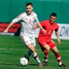 Denmark's Michael Silberbauer (2) dribbles the ball away from Canada's Russell Teibert (11) during the first half of a friendly soccer match at Kino Stadium in Tucson, Ariz., Saturday, Jan. 26, 2013. Pacific FC has parted ways with head coach Michael Silberbauer. THE CANADIAN PRESS/AP-John Miller
