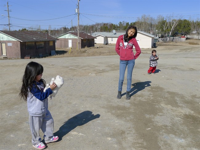 Children play outside at the North Caribou Lake First Nation, 320 km north of Sioux Lookout, Ontario on Thursday April 12, 2012. Isolation often takes the blame as the source of many problems on remote reserves. THE CANADIAN PRESS/Heather Scoffield