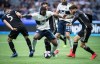 Vancouver Whitecaps' Doneil Henry, centre, attempts to move the ball as Sporting Kansas City's Matt Besler, left, and Ilie Sanchez, right, defend during the second half of an MLS soccer game in Vancouver, on Saturday, July 13, 2019. With just 13 regular season games remaining, the Whitecaps badly need a win Wednesday night on the road against the New England Revolution to keep their slim playoff hopes alive. THE CANADIAN PRESS/Darryl Dyck