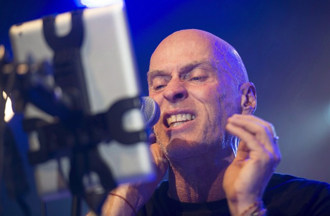 Spirit of the West frontman John Mann, who suffers from Alzheimer's, uses an iPad to assist him as he performs his final concert in Vancouver, Saturday, April 16, 2016. Though early-onset Alzheimer's has started to take away his musical memories, songs remain a vital outlet for Spirit of the West lead singer Mann. THE CANADIAN PRESS/Jonathan Hayward