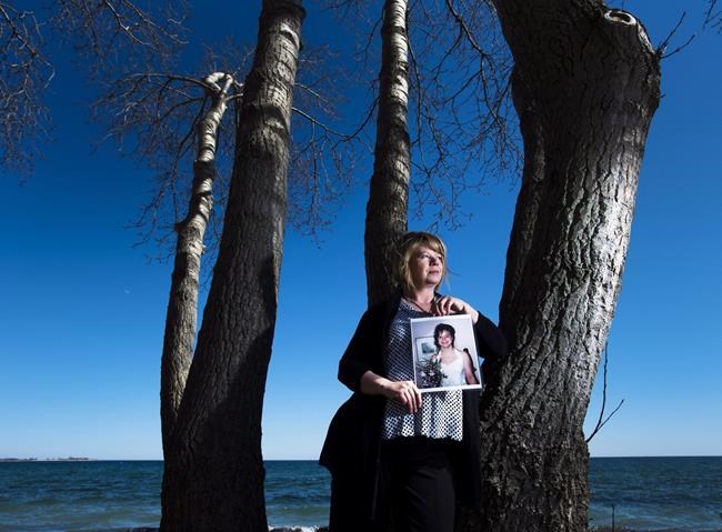 Donna May holds a photograph of her late daughter Jac in Toronto on Thursday, April 14, 2016. Donna May says she'll no longer tolerate a nod or weepy eyes on the opioid epidemic -- it's claimed the lives of too many people she loves. May wants action in the form of drug decriminalization and she's far from alone in her plea. The death of May's 55-year-old brother a year ago in Bolton, Ont. was a final straw that broke her emotionally. THE CANADIAN PRESS/Nathan Denette