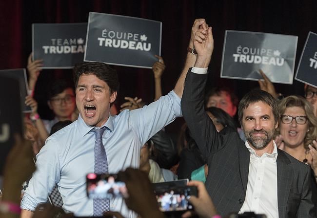 Prime Minister Justin Trudeau, left, raises the hand of Steven Guilbeault during an event in Montreal on July 10, 2019. This Montreal riding is shaping up to be a true three-way race for the NDP, Liberals and Bloc Quebecois. The NDP's Helene Laverdiere rode the