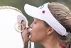 Golfer Brooke Henderson is the winner of the Bobbie Rosenfeld Award as The Canadian Press female athlete of the year. Henderson, of Smiths Falls, Ont., kisses the trophy after winning the CP Women's Open in Regina, Sunday, Aug. 26, 2018. THE CANADIAN PRESS Jonathan Hayward