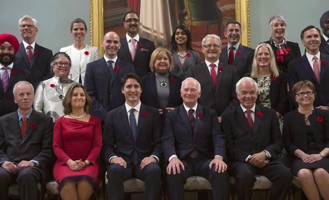 Governor General David Johnston (third from right) and Prime Minister Justin Trudeau (third from left) pose with members of the Liberal cabinet following a swearing-in ceremony, Wednesday Nov.4, 2015 in Ottawa. Trudeau received a lot of attention with his line about the calendar year when asked why he had named an equal number of men and women to cabinet after his newly elected Liberal government was sworn in. THE CANADIAN PRESS/Adrian Wyld