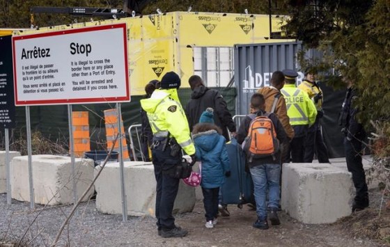 Paul Chiasson / THE CANADIAN PRESS FILESA family, claiming to be from Columbia, is arrested by RCMP officers as they cross the border into Canada from the United States as asylum seekers, on April 18, 2018. near Champlain, N.Y. A long-awaited legal look into whether the U.S. remains a safe country for refugees begins today at a Federal Court in Toronto. THE CANADIAN PRESS/Paul Chiasson