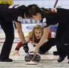 Michael Burns / THE CANADIAN PRESS
Jennifer Jones delivers her stone as lead Dawn Askin (right) and second Jill Officer brush on Thursday.
