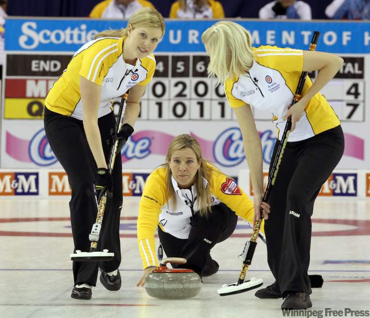 Frank Gunn / THE CANADIAN PRESS
Manitoba skip Cathy Overton-Clapham (centre) delivers a rock as second Leslie Wilson (left) and lead Raunora Westcott prepare to sweep during the afternoon draw against Quebec at the 2011 Tournament of Hearts in Charlottetown, PEI on Monday Feb. 21, 2011.