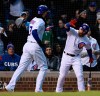 Chicago Cubs' Kris Bryant left, celebrates with teammate Willson Contreras after scoring on a Javier Baez sacrifice fly during the first inning of a baseball game against the Miami Marlins, Tuesday, May 7, 2019, in Chicago. (AP Photo/Paul Beaty)