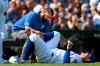 Chicago Cubs' Anthony Rizzo is tended to after spraining his ankle during the third inning of a baseball game against the Pittsburgh Pirates Sunday, Sept. 15, 2019, in Chicago. (AP Photo/Paul Beaty)