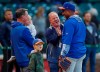 New York Mets bullpen coach Ricky Bones, right, jokes with fans during batting practice for the team's baseball game against the Chicago Cubs on Thursday, June 20, 2019, in Chicago. (AP Photo/Jim Young)