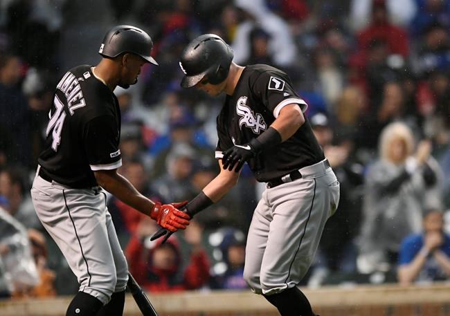 Chicago White Sox's James McCann right, celebrates with Eloy Jimenez left, after hitting a solo home run during the fourth inning of the team's baseball game against the Chicago Cubs on Wednesday, June 19, 2019, at Wrigley Field in Chicago. (AP Photo/Paul Beaty)