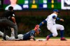 Milwaukee Brewers' Ben Gamel left, slides safely into second base as Chicago Cubs shortstop Javier Baez right, attempts to apply the tag during the ninth inning of a baseball game Saturday, Aug 31, 2019, in Chicago. Milwaukee won 2-0. (AP Photo/Paul Beaty)