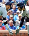 Milwaukee Brewers' Ryan Braun, right, celebrates with Yasmani Grandal after hitting a solo home run against the Chicago Cubs during the fourth inning of a baseball game Friday, May 10, 2019, in Chicago. (AP Photo/Nam Y. Huh)