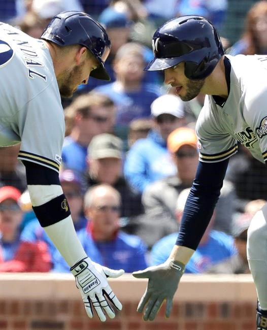 Milwaukee Brewers' Ryan Braun, right, celebrates with Yasmani Grandal after hitting a solo home run against the Chicago Cubs during the fourth inning of a baseball game Friday, May 10, 2019, in Chicago. (AP Photo/Nam Y. Huh)
