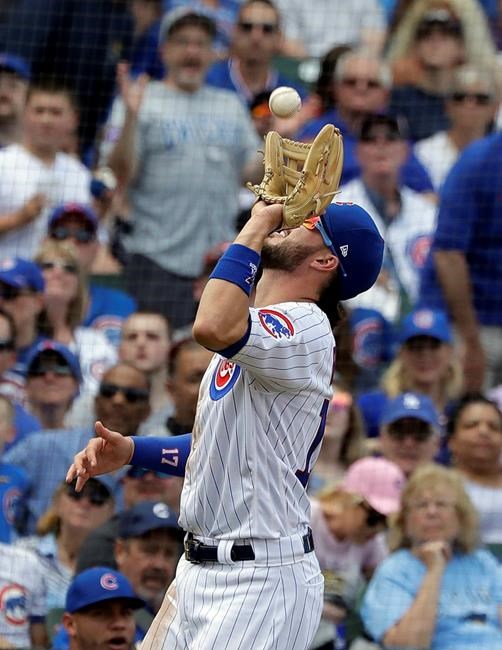Chicago Cubs third baseman Kris Bryant catches a fly ball hit by Cincinnati Reds' Derek Dietrich in foul territory during the fourth inning of a baseball game Saturday, May 25, 2019, in Chicago. (AP Photo/Nam Y. Huh)