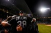 Chicago White Sox pitcher Zack Collins poses for photos with friends and family after the White Sox defeated the Chicago Cubs 3-1 during a baseball game Tuesday, June 18, 2019, at Wrigley Field in Chicago. (AP Photo/Paul Beaty)