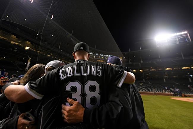 Chicago White Sox pitcher Zack Collins poses for photos with friends and family after the White Sox defeated the Chicago Cubs 3-1 during a baseball game Tuesday, June 18, 2019, at Wrigley Field in Chicago. (AP Photo/Paul Beaty)