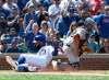 Chicago Cubs' Jason Heyward (22) is safe at home plate as Pittsburgh Pirates catcher Elias Diaz (32) takes the throw during the fourth inning of a baseball game, Saturday, July, 13, 2019, in Chicago. (AP Photo/David Banks)