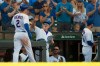 Chicago Cubs' Nico Hoerner (2) celebrates with manager Joe Maddon right, at the dugout after hitting a solo home run during the sixth inning of a baseball game against the Pittsburgh Pirates Saturday, Sept. 14, 2019, in Chicago. Chicago won 14-1. (AP Photo/Paul Beaty)