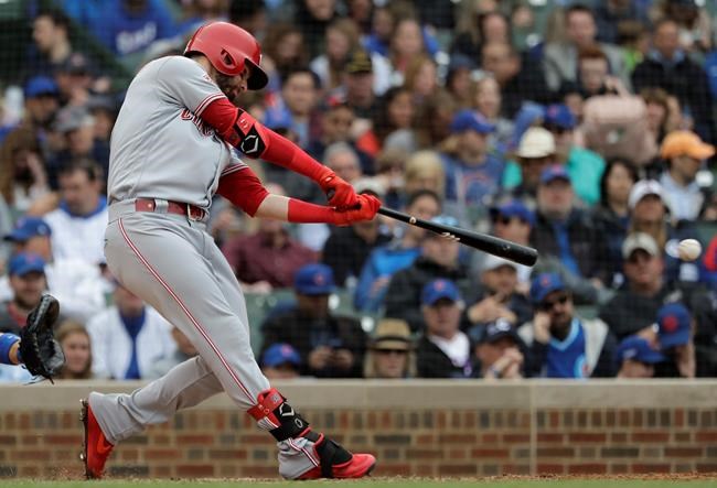 Cincinnati Reds' Jesse Winker hits a one-run double against the Chicago Cubs during the seventh inning of a baseball game Friday, May 24, 2019, in Chicago. (AP Photo/Nam Y. Huh)