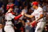 Cincinnati Reds catcher Tucker Barnhart and relief pitcher Raisel Iglesias celebrate the team's 4-2 win over the Chicago Cubs in a baseball game Tuesday, Sept. 17, 2019, in Chicago. (AP Photo/Charles Rex Arbogast)