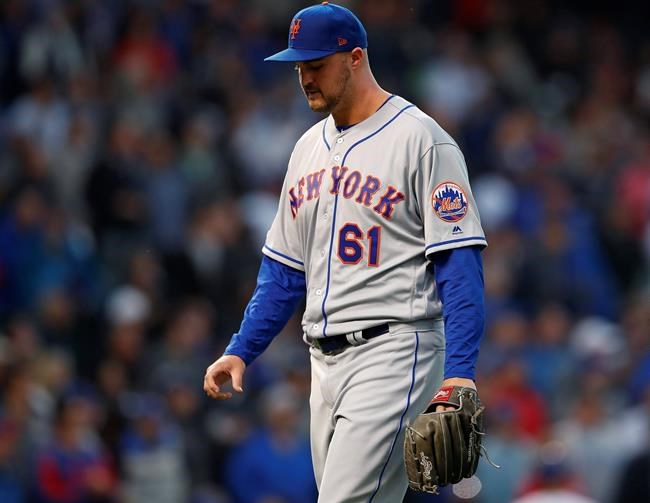 New York Mets' Walker Lockett walks back to the dugout after being taken out of the team's baseball game against the Chicago Cubs during the third inning Thursday, June 20, 2019, in Chicago. (AP Photo/Jim Young)