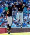 Pittsburgh Pirates' Starling Marte, right, celebrates with Josh Bell, left, after hitting three-run home run against the Chicago Cubs during the eight inning of a baseball game, Friday, July 12, 2019, in Chicago. (AP Photo/Kamil Krzaczynski)