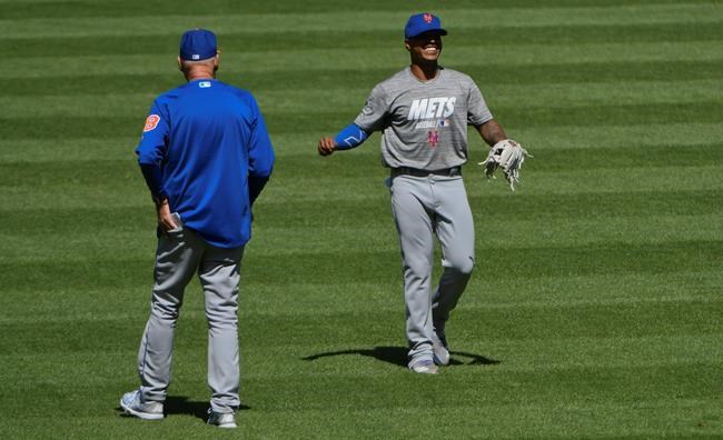 New York Mets pitcher Marcus Stroman, right, warms up as pitching coach Phil Regan looks on before a baseball game against the Chicago White Sox Wednesday, July 31, 2019, in Chicago. (AP Photo/Matt Marton)