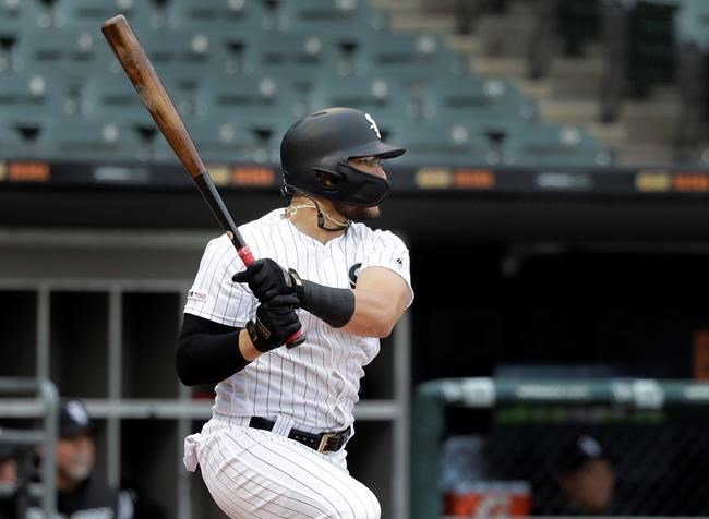 Chicago White Sox's Yolmer Sanchez watches his game-winning single off Kansas City Royals relief pitcher Kevin McCarthy during the ninth inning of a baseball game that was suspended due to rain a day earlier, in Chicago, Tuesday, May 28, 2019. The White Sox won 2-1. (AP Photo/Charles Rex Arbogast)