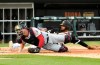 Chicago White Sox's Jose Rondon, back, is safe at home as Minnesota Twins catcher Mitch Garver, front, can't handle an errant throw during the second inning of a baseball game, Saturday, July 27, 2019, in Chicago. (AP Photo/David Banks)