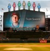 The Chicago White Sox have a moment of silence for Los Angeles Angels pitcher Tyler Skaggs, whose image is shown on the scoreboard. before a baseball game between the Detroit Tigers and the White Sox on Tuesday, July 2, 2019, in Chicago. Skaggs died Monday. (AP Photo/Jeff Haynes)