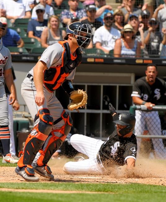 Chicago White Sox's Yolmer Sanchez, right, slides safely into home plate as Detroit Tigers catcher John Hicks (55) waits for the throw during the fourth inning of a baseball game Wednesday, July 3, 2019, in Chicago. (AP Photo/Mark Black)